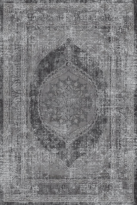 Alfombra 'Aria' mostrando su diseño texturizado en tonos de gris, negro y blanco, con un patrón central de medallón y bordes ornamentales que evocan estilos persas y turcos. El medallón oscuro contrasta con el fondo claro, dando un aspecto vintage. La alfombra es lavable en lavadora, con base antideslizante y sin pelusa.