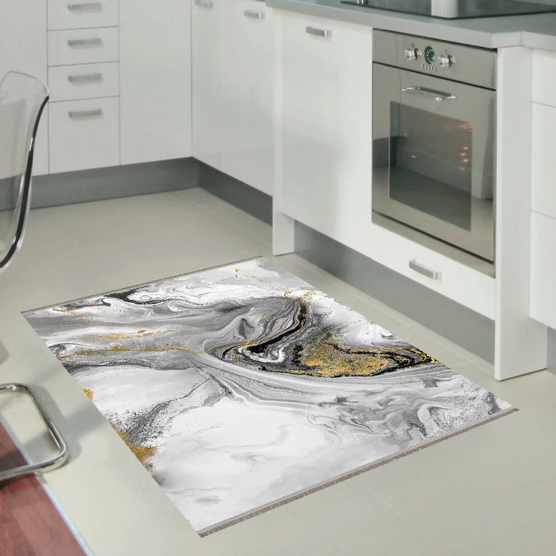 Alfombra 'Mármol' en una cocina moderna con gabinetes blancos, resaltando su diseño en tonos de gris y blanco con detalles dorados, añadiendo elegancia al espacio contemporáneo