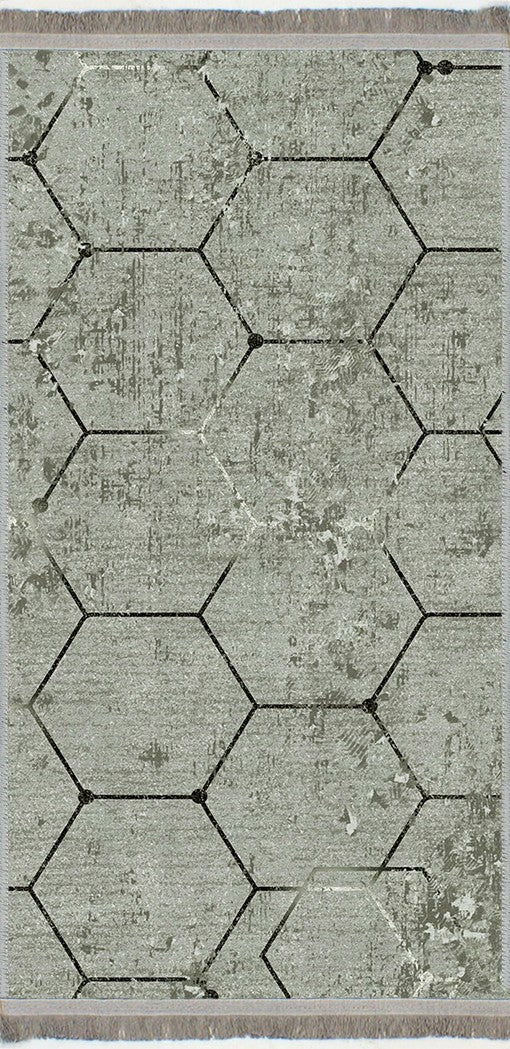 Alfombra 'Terra' sobre un fondo blanco, destacando su diseño hexagonal en tonos grises, ideal para añadir un toque de elegancia moderna y contemporánea a cualquier decoración.