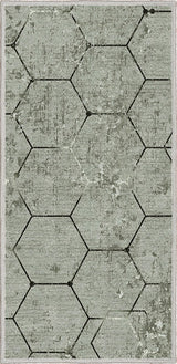 Alfombra 'Terra' sobre un fondo blanco, destacando su diseño hexagonal en tonos grises, ideal para añadir un toque de elegancia moderna y contemporánea a cualquier decoración.